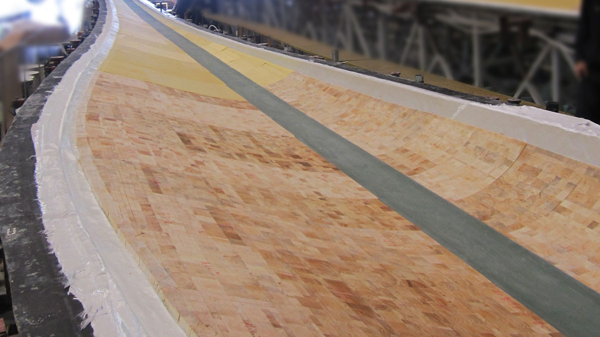 Balsa core material being shaped into a large curved mold for composite manufacturing